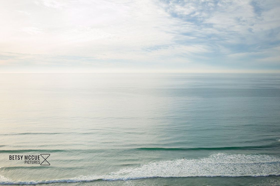 Peaceful blue waves and blue skies of a beach