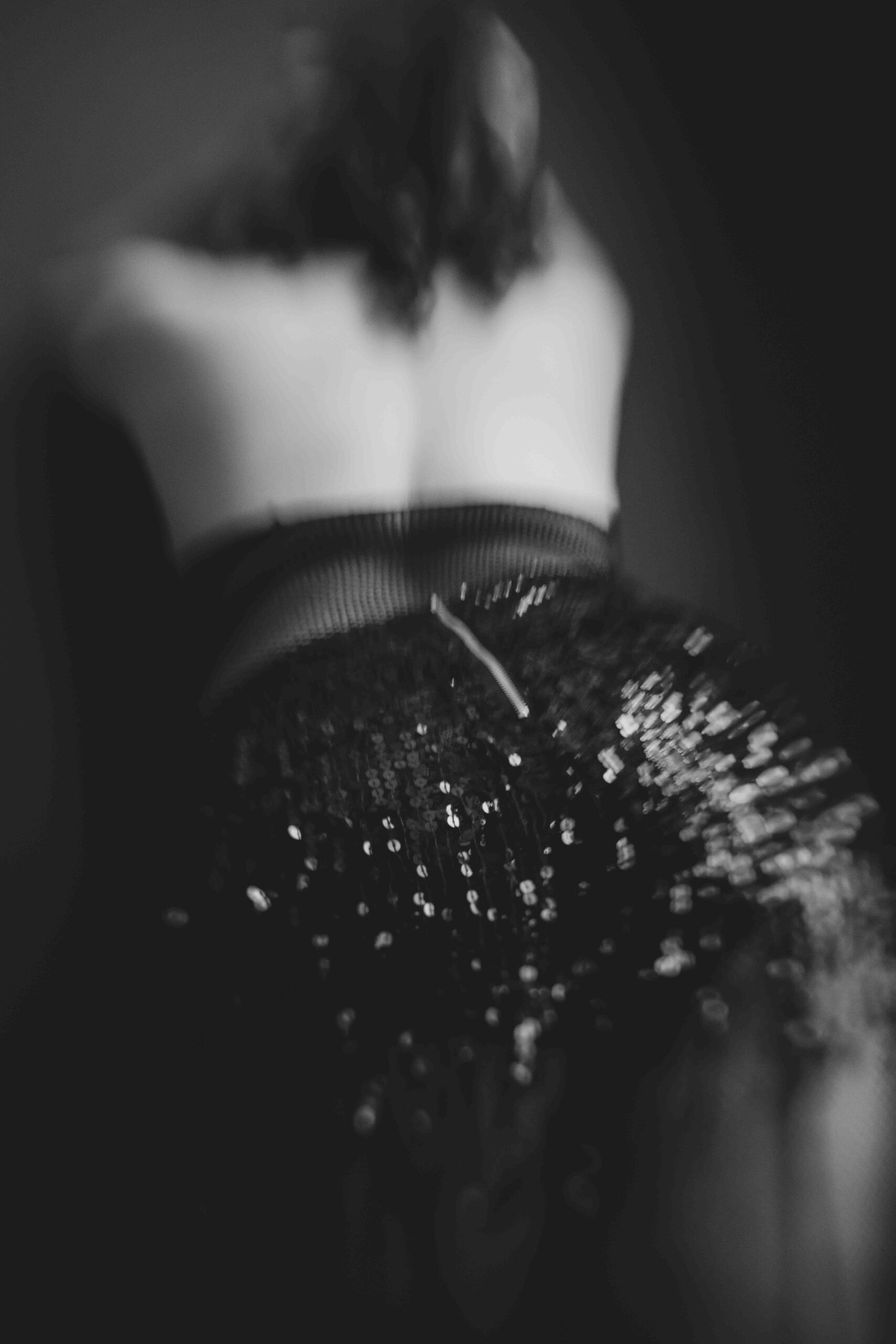 Back side photo of a woman wearing black lingerie.