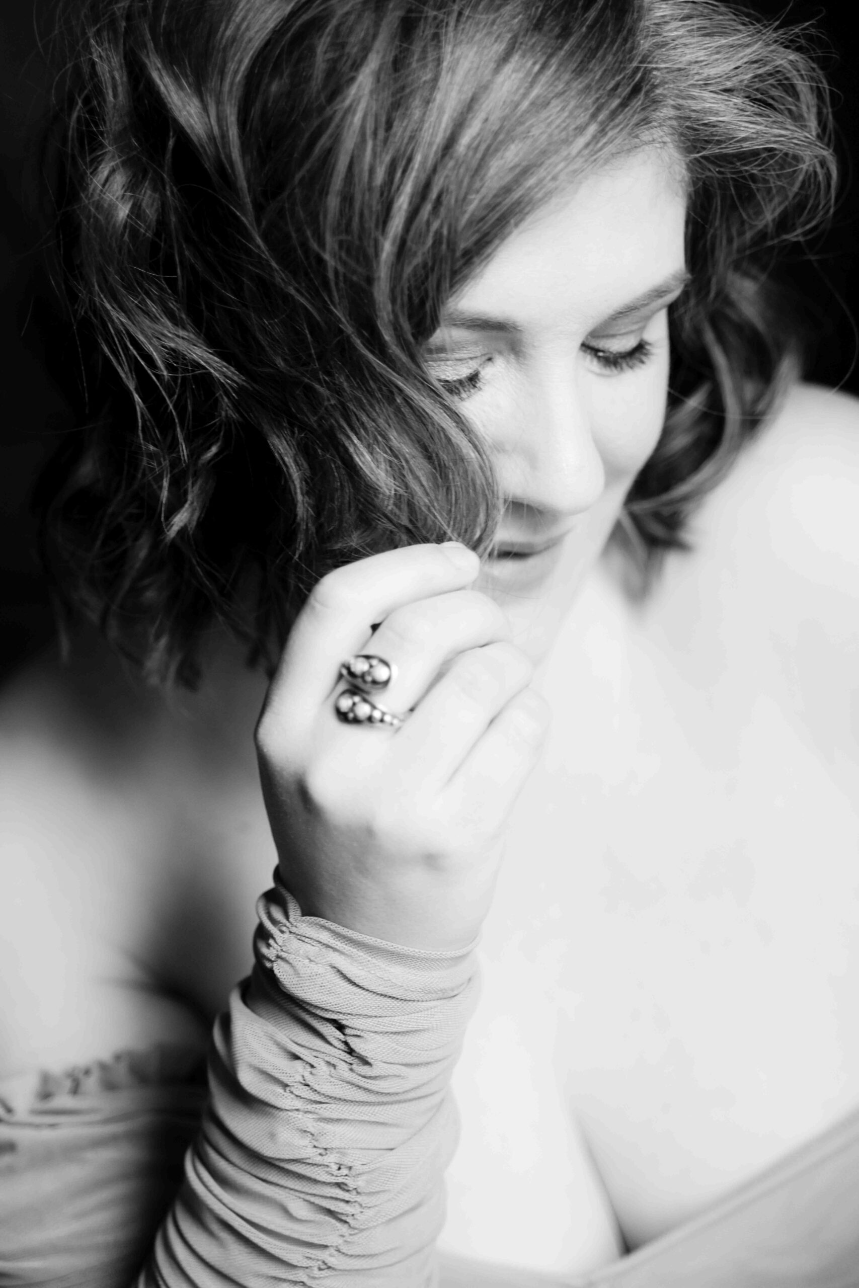 Black and white photo of a woman looking down.