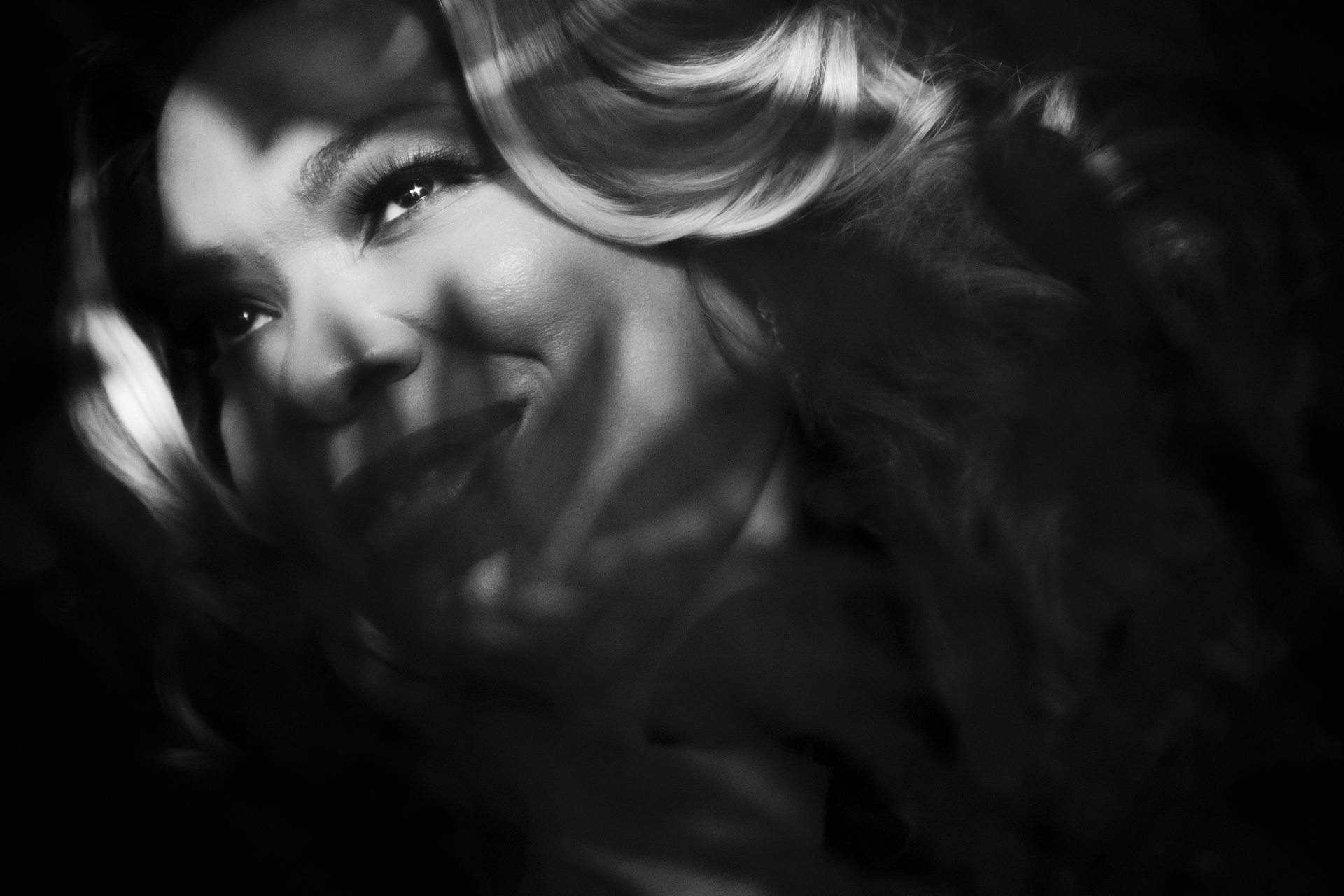 voyeuristic bw black woman smiling through leaves boudoir photo kalamazoo female studio